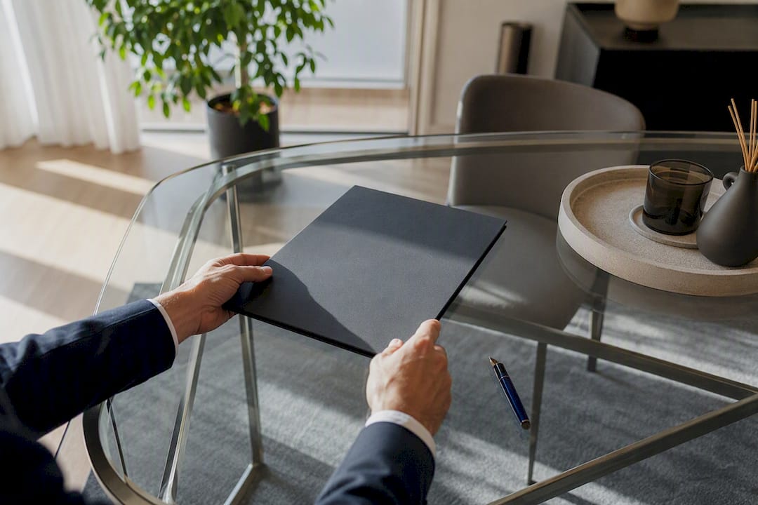 Hände mit Stift und Ordner auf dem Schreibtisch